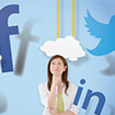A woman thinking with the facebook, twitter, linkedin, and youtube logos hovering around her head.